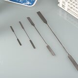 Double-sided spatula with an angular/rounded edge, made of stainless steel